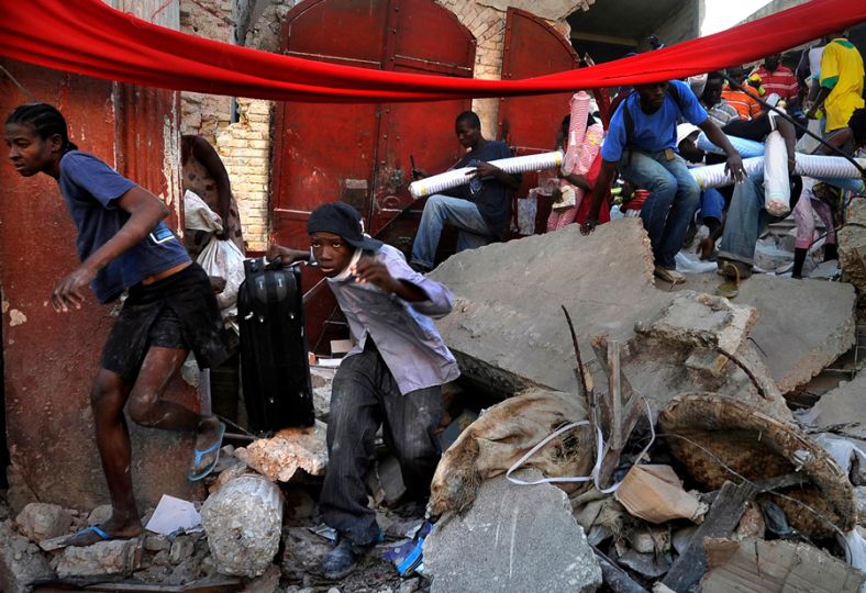 'Chaos' Desperate Haitian survivors take goods from stores in the market area of Port-au-Prince as chaos erupts in the streets. The price of what few staples remain in the city had soared, fuel supplies had dwindled, and thousands of Haitians had abandoned listing homes for squalid tent cities springing up in even the smallest public spaces. Public parks and tennis courts filled with families carrying what possessions they had left. (Carol Guzy, The Washington Post - January 16, 2010)
