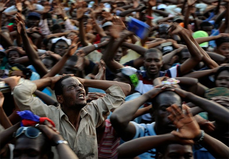 'Prayer' Survivors participate in a day of prayer at Champs du Mars in Port-au-Prince. Almost no one, it seemed, was spared tragedy. In a country whose government has all but collapsed, whose feeble economy has been crushed and whose people have been left destitute, the challenges were daunting. (Nikki Kahn, The Washington Post- January 23, 2010)