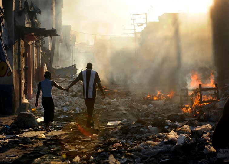 'Life Amid the Ruins' A couple holds hands and walks amid the wreckage of their country's wounded landscape. Experts familiar with the rebuilding efforts in Haiti say relief work is finally speeding up under the guidance of the Interim Haiti Recovery Commission. The group has set a goal of removing 40 percent of the earthquake rubble by October and has approved projects such as highways, apartment buildings and 250 temporary schools for children. But even with these projects underway, rebuilding Haiti will take many years. (Carol Guzy, The Washington Post - January 19, 2010)