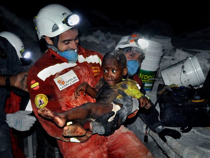 'Rescue' Relief efforts were severely hampered by the fact that government agencies and international organizations charged with helping coordinate assistance operations had themselves been shattered by the quake. But there were moments of hope amid the despair: A tiny baby named Reggie Claude is rescued from the rubble of his home. Disaster relief workers and family members rejoiced as Oscar Vega carried the child through the streets. (Carol Guzy, The Washington Post - January 14, 2010)