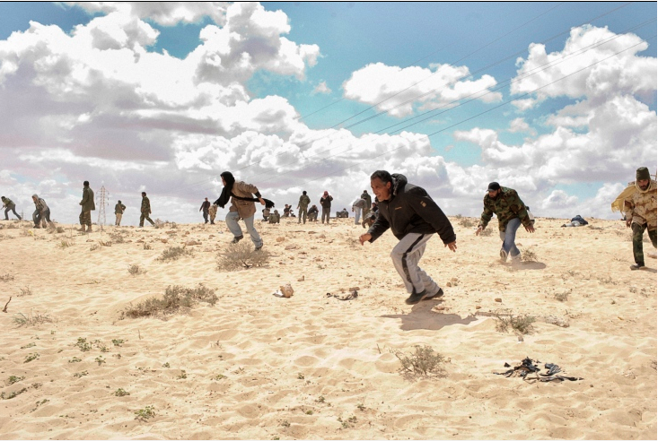 Libya, Part 1. u201dKozyrev delivered a visual dispatch from Libya, where he was following rebel fighters as they parried with the forces of Muammar Qaddafi. Here, rebel fighters scatter under fire outside the city of Ajdabiya on March 22. u201d Photo by Yuri Kozyrev/Noor for Time