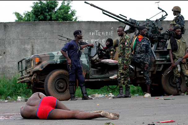 Ivory Coast, Part 2. u201dHere, fighters loyal to Alassane Ouattara, the internationally recognized winner of November's election in Ivory Coast, stand in an Abidjan street behind an injured man.u201d Photo by Emmanuel Braun/Reuters, Time, April 11