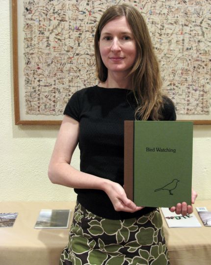 Photographer Paula McCartney with her monograph, Bird Watching, in the Indie PhotoBook Library