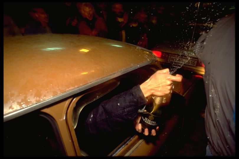 Check Point Charly, Berlin. Nov. 10, 1989.rn24 hours after the first breach in the Berlin Wall, East Berliners are being allowed to drive across into West Berlin. Trabbis are lined up to cross the border and cheap Champagne is uncorked © Thomas Haley
