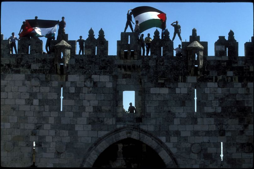 Jerusalem, Israel. Sept. 10, 1993.rnFor the first time, Palestinians wave their flag over the Damascus Gate. Israel has recognized the PLO and in a couple of days Yitsack Rabin and Yassir Arafat are going to shake hands on the lawn of the White House © Thomas Haley