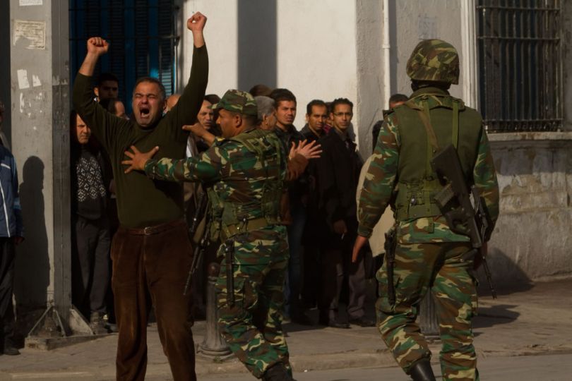 Tunis, Tunisia. Jan. 15, 2011rnFollowing the departure of Pres. Ben Ali, Tunisians continue to demonstrate their anger and years of frustration on the main street of Tunis. The army is considered to be on the side of the people (as opposed to the police force) and this soldier tries to calm this angry protestor © Thomas Haley