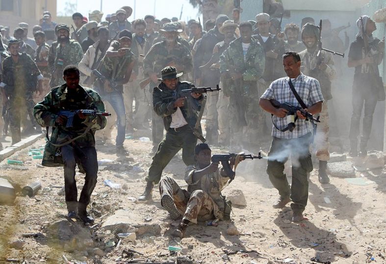 ”The battle for Surt, the tribal stronghold of former Libyan leader Muammar el-Qaddafi, raged throughout the week. Photographer Ahmad Al-Rubaye put himself in front of the front lines to get this shot of Libyan National Transition Council fighters. At last the city fell to the Transition Council army, marking the end of one era in Libya, and the beginning of another.” Photo by Ahmad Al-Rubaye/AFP/Getty Images, “Framework,” Los Angeles Times