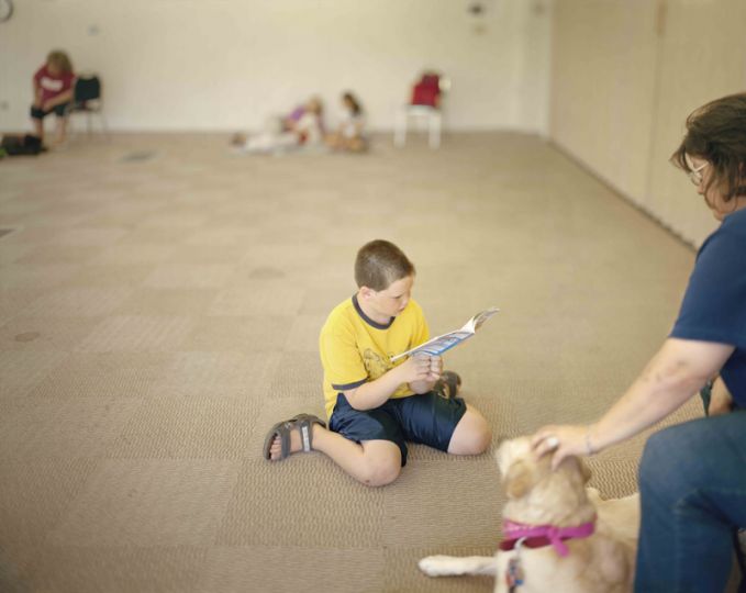 Reading to dogs, Bethlehem Area Public Library, Bethlehem, Pennsylvania, 2011 rn© Judith Joy Ross - Courtesy Pace/MacGill Gallery