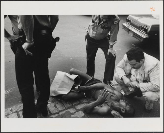 Leonard Freed
New York City, 9th Police Precinct, Man Reported Sick on City Street, Waiting for Hospital Wagon
1978
Gelatin silver print
Museum of the City of New York. ©Leonard Freed / Magnum Photos
