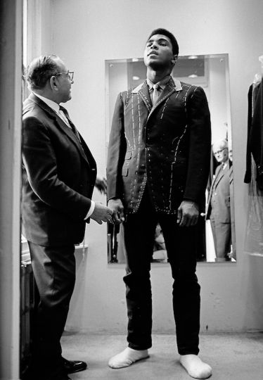 Ali is measured for a bespoke suit by a tailor in London’s Seville Row, 1966 © Muhammad Ali, photographed by Thomas Hoepker, 1966