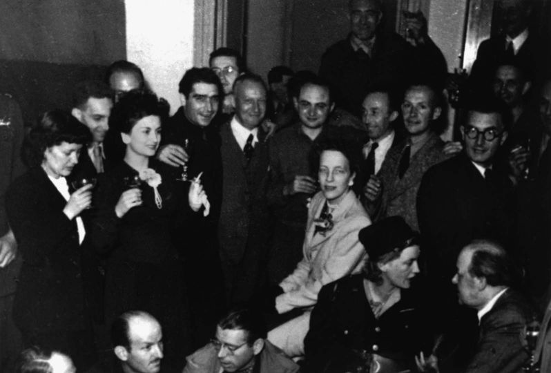 Paris. 27th August 1944. A party given in the home of the Paris Vogue editor Michel de Brunhoff, shortly after the liberation of Paris, brought together John MORRIS (rear center with glasses). On his right: Robert CAPA. On his left (glasses): David SEYMOUR 