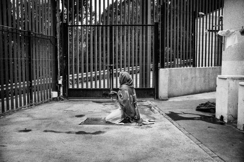 Spain, Ceuta, April 10 2012. A muslim women from Ivory Coast is praying in the backyard of CETI. She is one of the few women guests inside the centre. © Gianfranco Tripodo
