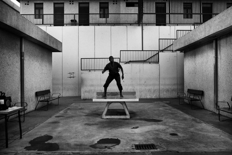 Spain, Ceuta, April 9 2012. A guest of CETI is dancing on top of a table tennis. African and American hip hop music is constantly played in the courtyard of CETI. © Gianfranco Tripodo