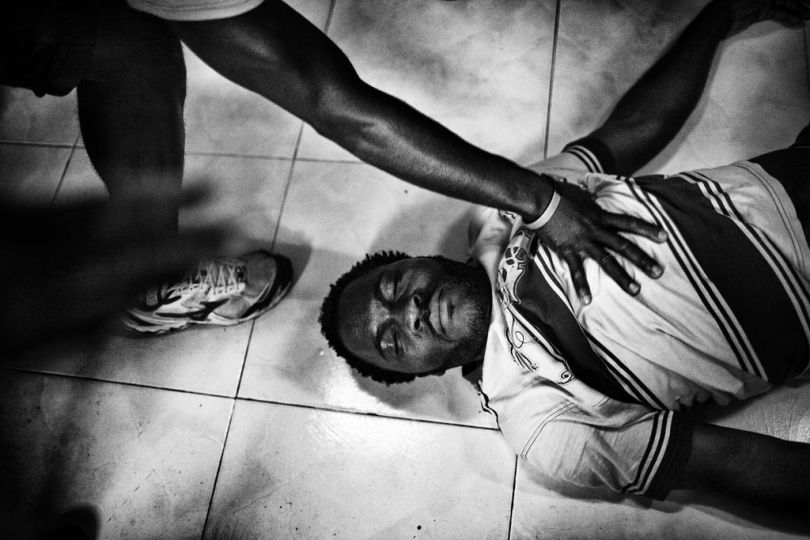 Spain, Ceuta, March 31 2012.  Wilson from Cameroon is performing a traditional African dance inside the headquarter of CETI. © Gianfranco Tripodo