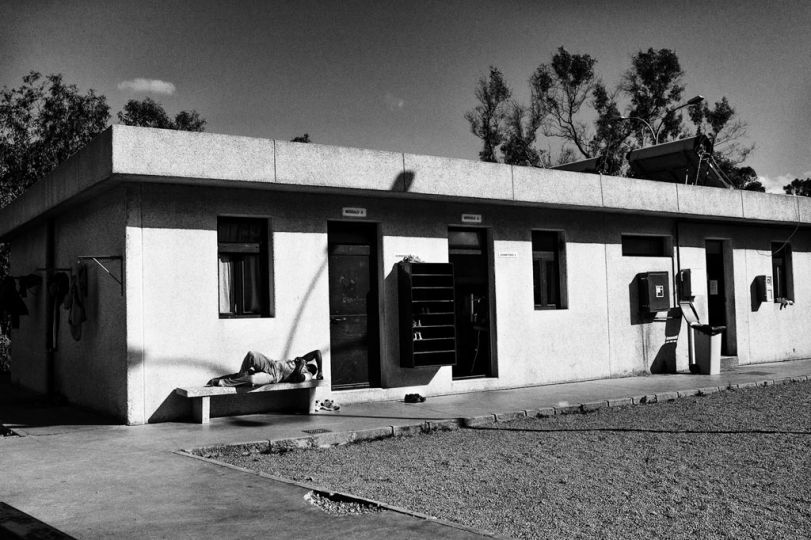 Spain, Ceuta, April 10 2012. One guest of CETI is resting on a bench inside the main courtyard. © Gianfranco Tripodo