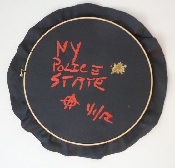 u201cNY Police Stateu201d, 2012rnEmbroidery thread, satin, sewing hoop. © Frances Goodman