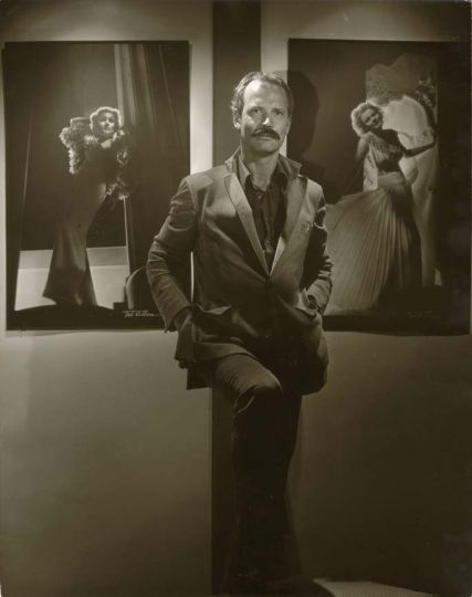 John Kobal flanked by portraits of Carole Lombard and Madeleine Carroll at the studio of photographer Ted Allan 1981