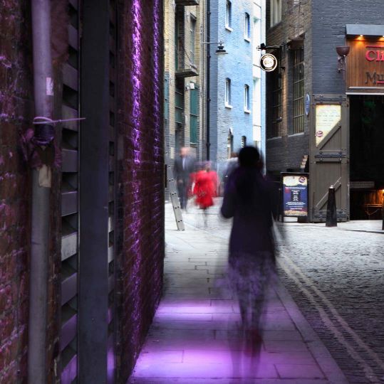 Clink Street, with Clink Prison Museum on right, Southwark, London, UK. The Clink Prison, founded 1144, gave its name as slang to all prisons. Atmospheric street scene with pedestrians. © Manuel Cohen
