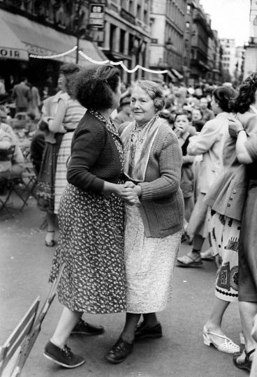 Dancing in the streets, Paris, 1953 Gelatin silver print; printed c.1953 11 3/4 X 8 inches Titled and dated in ink, and two David Seymour/Magnum Photos stamps on print verso. © Chim (David Seymour)/Magnum Photos