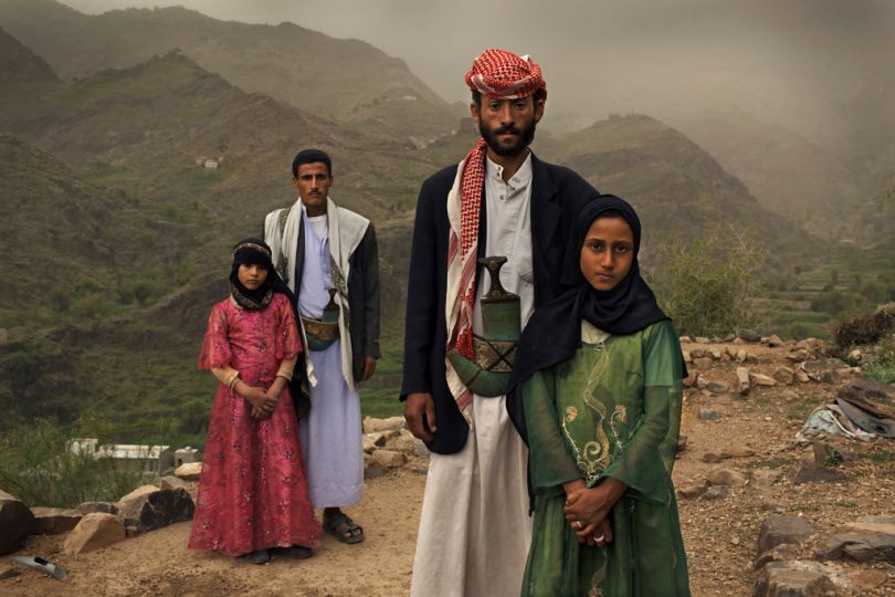 Tehani, 8 (Yemen), 2010. “Whenever I saw him, I hid. I hated to see him,” Tehani (in pink) recalls of the early days of her marriage to Majed, when she was 6 and he was 25. The young wife posed for a portrait with former classmate Ghada, also a child bride, outside their home in Hajjah, Yemen. © Stephanie Sinclair/ VII/ Tooyoungtowed.org