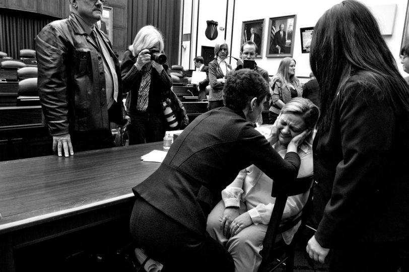 Sergeant Jennifer Norris was 21 when she joined the US Air Force, and was drugged and raped by her recruiter at Lackland Air Force Base in San Antonio, Texas. Nancy Parrish, President of the association “Protect Our Defenders,” is seen comforting her after she testified at the hearing of the US House Committee on Armed Services on Capitol Hill.  © Mary F. Calvert / Zuma Press. Canon Female Photojournalist Award 2013 presented by the AFJ