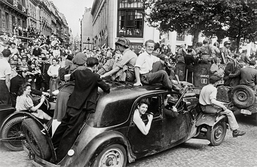 August 26, 1944: The Liberation of Paris: Victory Celebrations on the Champs-Élysées. © Robert Capa/Magnum Photos.