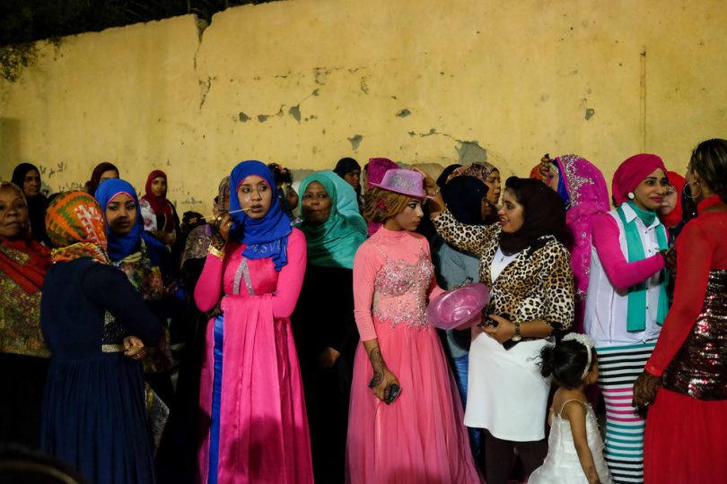 Young women, dressed in more universal fashionable hijab styles, socialising at a wedding in Aswan.