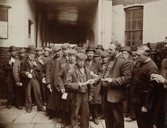 Court Yard Salvation Army barracks Sunday Morning rush—men who had had tickets given them during the night for free breakfast. London, 1902  . © Henry E. Huntington Library