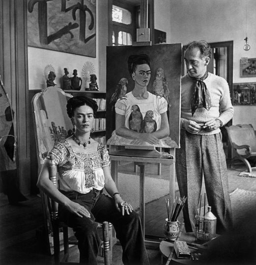 Nickolas Muray, Frida Painting “Me and My Parrots” (with Muray), 1939, Courtesy of the Estate and PDNB Gallery, Dallas, TX