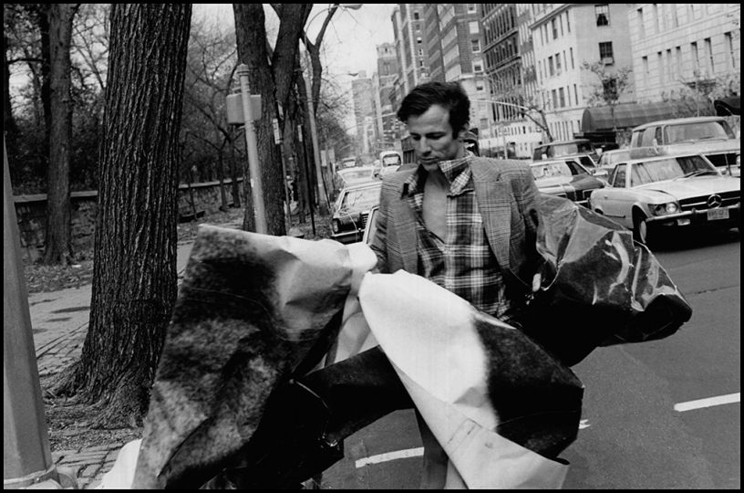 Beard with his arms full of sections from the canvass mural on the streets of Manhattan © Orin Langelle