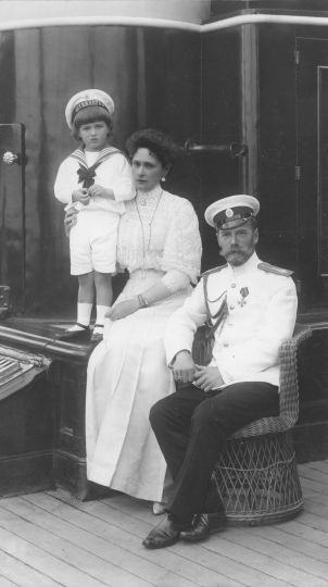 Family portrait. The emperor Nicholas II, the empress Alexandra Feodorovna and the crown prince aboard the yacht Standart. K. E. Gan. Russian State Archive of the Navy