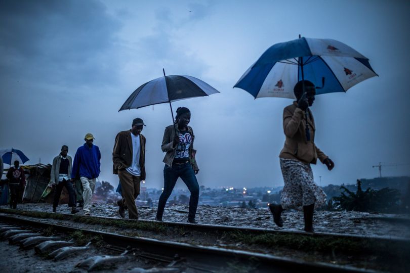 Kibera: Stories From Within © Brian Otieno 1st Place - Residents walk along the muddy rail track in Kibera after heavy rains in Kibera on March 4, 2018.