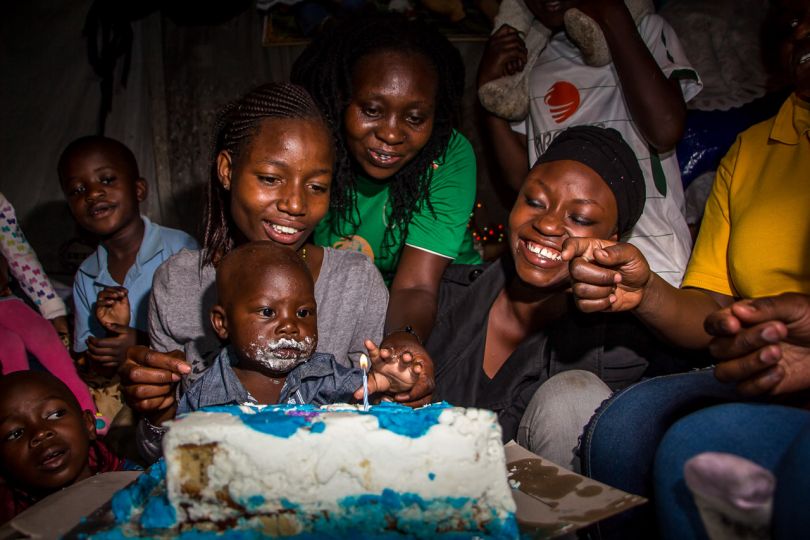 Kibera: Stories From Within © Brian Otieno 1st Place - Prince Adrian, surrounded by families and friends celebrates his birthday as he turned 1 year old on June 3rd, 2016.
