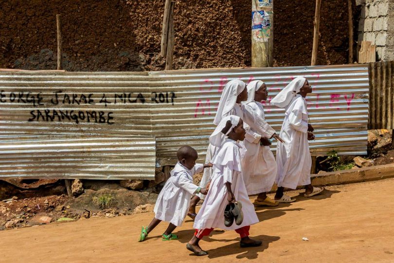 Kibera: Stories From Within © Brian Otieno 1st Place - Children from the Legio Maria head to church wearing their traditional white worship ropes.