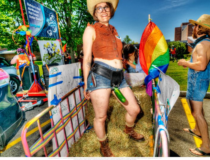 3. She Wore a Substantial, Erect, Cucumber Dildo Deftly Attached to a Snap-On Harness with Plastic Electrical Wire-Ties, and Broadly Smiled, Displaying Potentially Dangerous Choppers. Preparing for Buffalo’s Pride Parade, Sunday Morning, June 7, 2015. © Les Krims