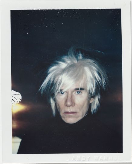 Andy Warhol, Self-Portrait in Fright Wig, 1986, Polacolor ER, 10.8 x 8.5 cm. © 2018 The Andy Warhol Foundation for the Visual Arts, Inc. Licensed by DACS, London. Courtesy BASTIAN, London