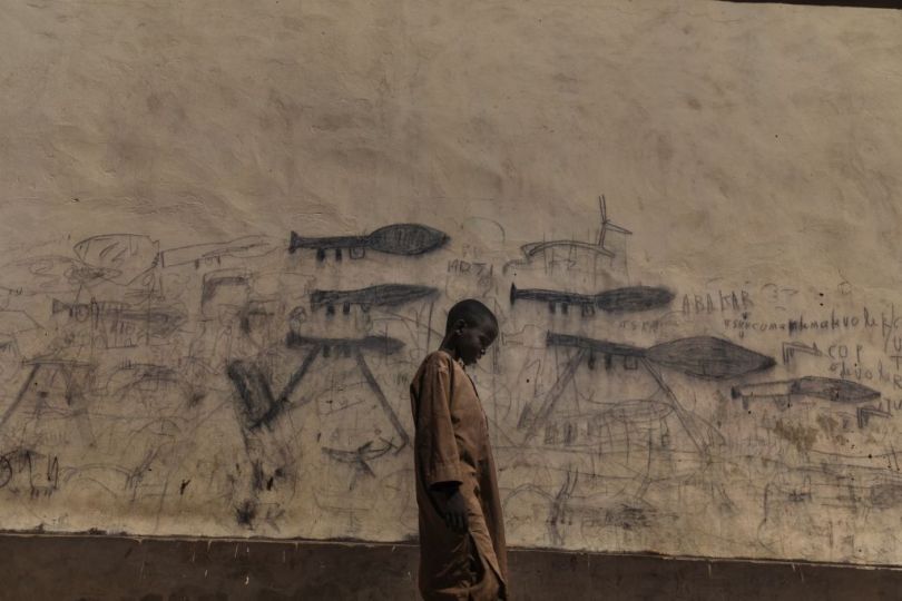 Africa, Chad, 13th October 2018. Orphaned children, mainly Nigerian refugees, live together as a group in the Koran schools. During the day, they go begging and are known as Almajiri. These children, who live in the Lake Chad basin, are growing up in a constant situation of war, and all they’ve ever known is the weapons and deaths they draw on the walls of the city.  Almajiri is gotten from an Arabic word 