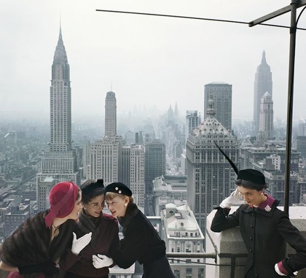 Fashion models wear a variety of hats on the roof of the Conde Nast Building against a view of the New York skyline for Vogue, 1949, Manhattan, New York City. Young Velvets, Young Prices, Hat Fashions, American Vogue, October 1949 © Norman Parkinson Archive / Courtesy Iconic Images 
