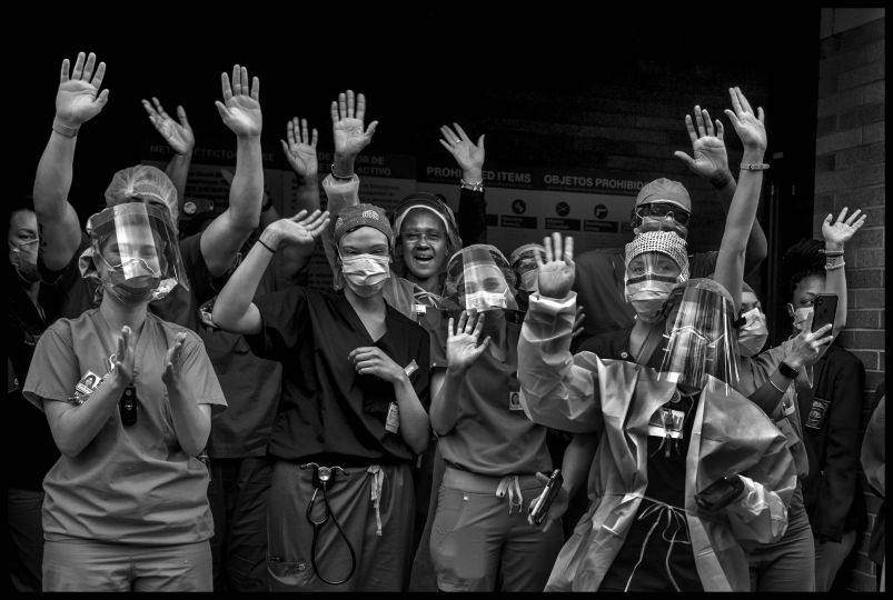 Healthcare workers from Mount Sinai Hospital working with coronavirus patients come outside at 7pm to hear the applause and expressions of gratitude, for their brave and courageous work, from the public of New York, at 7pm.
April 20, 2020. © Peter Turnley. ID# 27-001