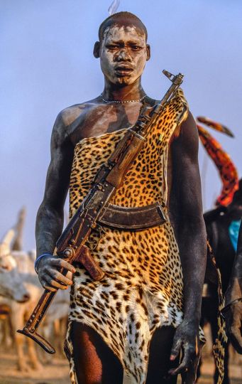 Carol Beckwith and Angela Fisher Dinka - Warrior with Leopard Skin and Kalashnikov Rifle, South Sudan, 2006 © Carol Beckwith and Angela Fisher / Courtesy Staley-Wise Gallery, New York