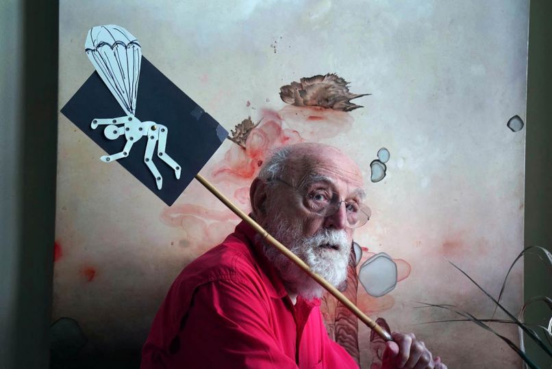 Duane Michals in studio. Photo courtesy of Michael Scalisi. Artwork: Darren Waterston, Pleasure Realm, 2012. Oil on wood panel, 36 x 36 inches