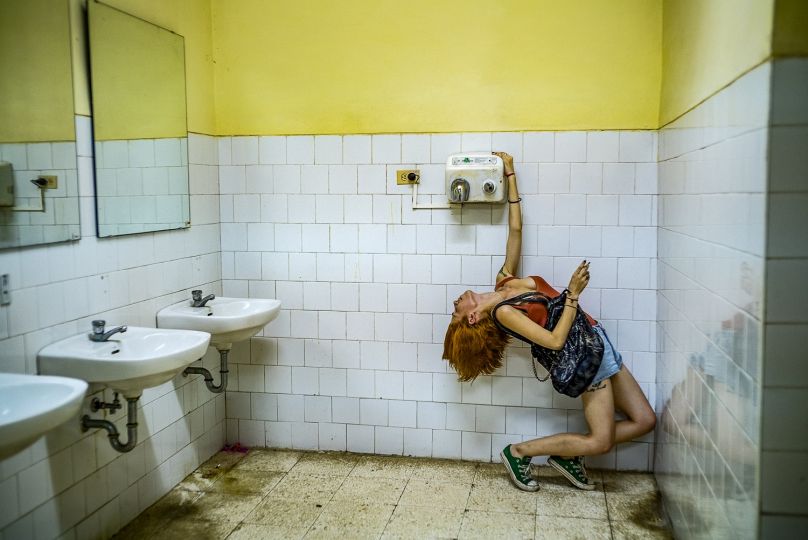 CUBA. HAVANA. 2015. Helen, dancing around a bathroom. The blow dryer was not working. © Michael Christopher Brown