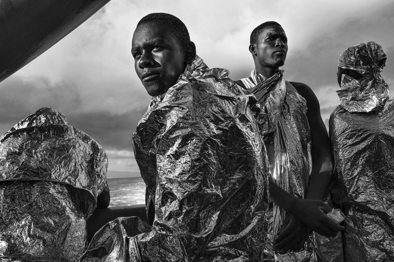 After spending two days and two nights on the MSF Bourbon Argos, rescued migrants catch sight of the Italian coast for the first time. 23 August 2015 © Francisco Zizola