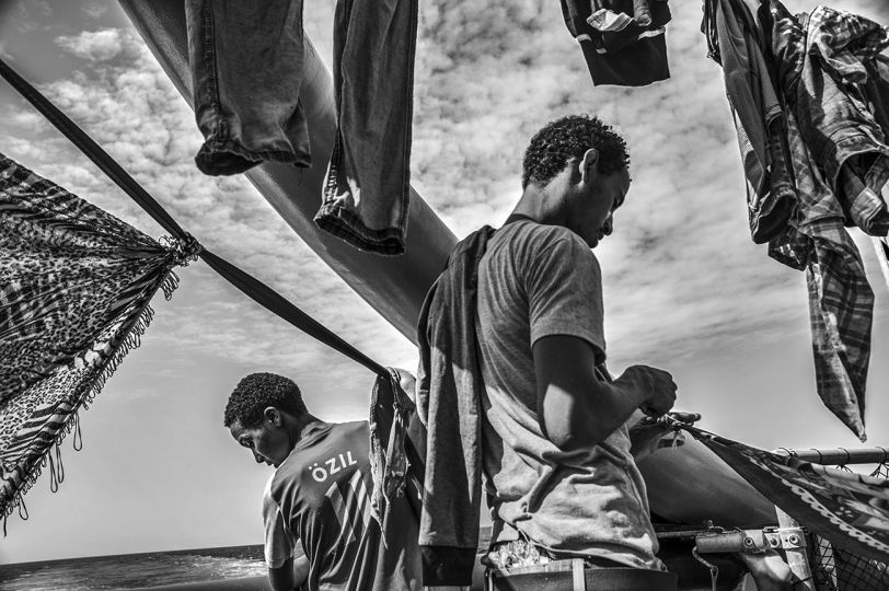Migrants on board the MSF Bourbon Argos sail towards Italy after being rescued the day before in the Mediterranean Sea, off the Libyan coast. 3 September 2015. © Francisco Zizola