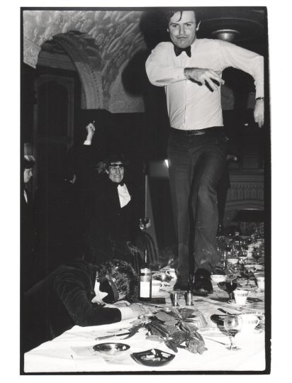 Onanist dining club, Oxford Union, Macmillan Room,a man racing down a table March 1981, from 