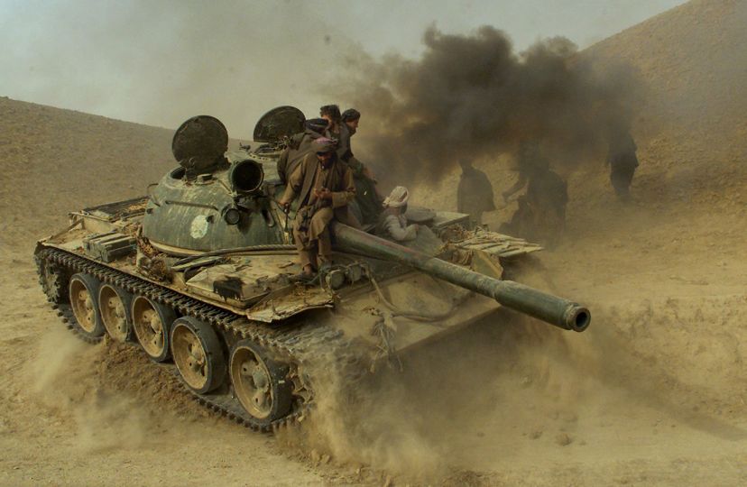 Defecting Taliban fighters maneuver a tank through the front line  near the village of Amirabad, between Kunduz and Taloqan, Saturday, Nov. 24, 2001. Hundreds of Taliban defected to the northern alliance Saturday, paving the way for the fall of Kunduz where several thousand foreign fighters are said to remain. (AP Photo/Jerome Delay)