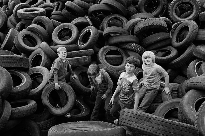 Boys and Tires, Sears Point,  1976 - The White Sky © Mimi Plumb – Courtesy Robert Koch Gallery