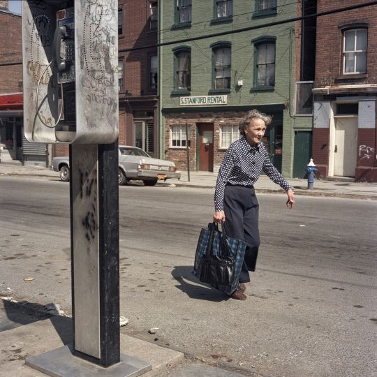 Woman Walking in the Street, Hudson River Town, 1986 © Janet Delaney - Courtesy of the artist and EUQINOM Gallery