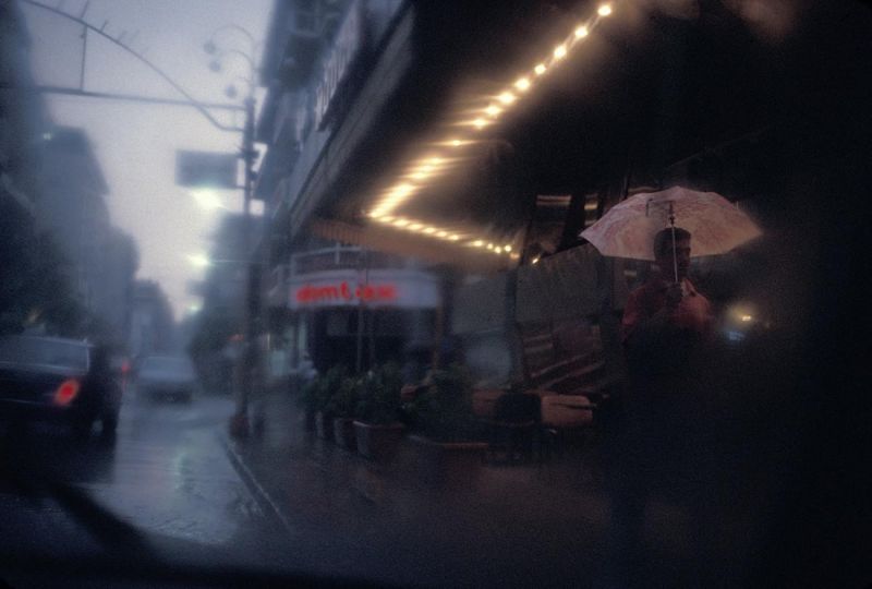 BEIRUT, LEBANON, 1996 A man walks through the rain on Hamra Street. © Ed Kashi - Courtesy Kehrer Verlag