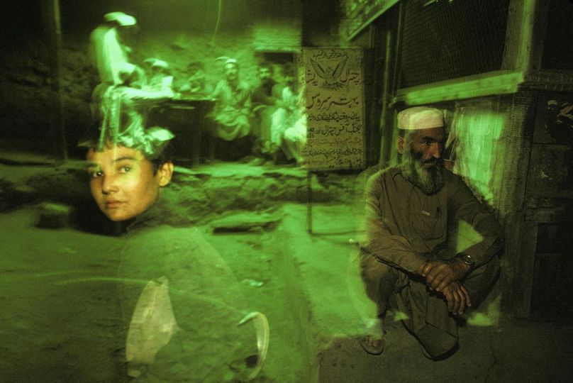 CHITRAL, PAKISTAN, 1998 Commuters walk through the Chitral Bus Depot, located near the Afghanistan border. © Ed Kashi - Courtesy Kehrer Verlag